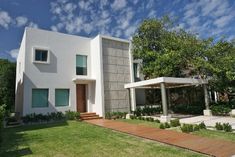 a white house sitting on top of a lush green field