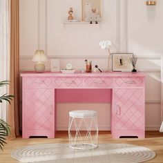 a pink desk and chair in a room