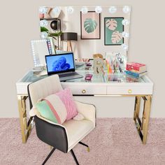 a desk with a chair, laptop and other items on it in front of a mirror