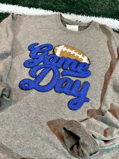 Show off your game day spirit in this cozy chenille patch sweatshirt! Tailgate in comfort and style with this must-have sweatshirt, in your favorite team colors! Go team! All Chenille Patches are sewn on! Not heat applied! Team-colored Fleece Top For Game Day, Winter Game Day Sweatshirt With Team Logo, Collegiate Team-colored Sweatshirt For Baseball Season, Game Day Fleece Sweatshirt With Team Logo, Fall Varsity Sweatshirt With Team Logo, Varsity Style Team-colored Sweatshirt For Fan Gear, Game Day Varsity Sweatshirt With Ribbed Cuffs, Varsity Sweatshirt With Embroidered Logo For Fans, Varsity Long Sleeve Sweatshirt For Game Day