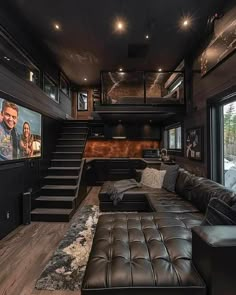 a living room filled with furniture and a flat screen tv mounted to the side of a wall