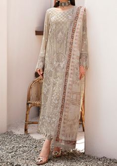 Introducing our Chiffon collection DASTAN by Ramsha designed to make you look and feel your best These pieces will add a touch of class and elegance to your wardrobe. This collection is a beautiful collection of ensembles offering versatile compositions for the latest festive wardrobe requirements. Embroidered Chiffon Front With Sequence. Embroidered Chiffon Back and Sleeves. Embroidered Organza Lace. Embroidered Organza Ghera, and Trouser Lace. Embroidered Net Dupatta. Raw Silk Trouser. Color: There might be slight color variation due to lighting and flashes while the photo shooting. The color may also vary because of different screen resolutions. Wash Care: Dry Clean Only. Silk Wedding Dress Pakistani, Elegant Beige Georgette Sets, Elegant Georgette Dress With Traditional Drape, Elegant Dress With Chikankari Embroidery, Festive Beige Georgette Dress, Bohemian Georgette Dress For Eid, Silk Chiffon Dress For Eid Party, Silk Chiffon Party Dress For Eid, Elegant Silk Chiffon Dress With Dupatta