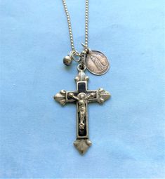 "A Unique One of a Kind Religious Gift AN ANTIQUE CRUCIFIX ASSEMBLAGE NECKLACE A BEAUTIFUL ART DECO CROSS NECKLACE MADE WITH: AN ANTIQUE SILVER & BLACK ENAMEL ART DECO CRUCIFIX FROM THE EARLY 1900'S MADE WITH ANTIQUE SILVER WITH A HIGH CONTENT OF SILVER IT IS ATTACHED TO THE NECKLACE WITH A STERLING SILVER BAIL IT MEASURES 1 7/8 INCHES LONG X 1 1/4 INCH WIDE  4 MM ROUND ANTIQUE SILVER ROSARY BEADS I HAND WRAPPED WITH STERLING SILVER  SILVER AN ANTIQUE OLDER STYLE OUR LADY OF LOURDES RELIGIOUS MEDAL MARKED GROTTE DE LOURDES ON THE REVERSE SIDE MEASURING 5/8 INCH WIDE X 3/8 ACROSS AN 18 INCH ANTIQUE CHAIN NECKLACE IS INCLUDED BONUS - Every Jewelry Purchase is packaged in a lovely Jade Green Gift Box measuring 3.5\"x 3.5\" and arrives ready for gifting" Crucifix Art, Religious Jewelry Catholic, Silver Rosary, Mary Necklace, Enamel Art, Necklace Art Deco, Virgin Mary Necklace, Assemblage Necklace, Lady Of Lourdes