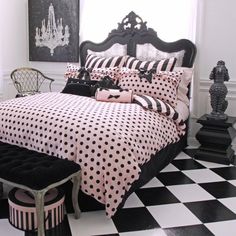 a black and white bedroom with polka dot bedding