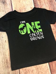 "Celebrate your little ones first birthday in \"Dino\" style! all ages available Does your little one love dinosaurs like mine?? These super cute birthday shirts are perfect for any dinosaur party! Available in any age, and for any family member! Please leave age in notes. If. I thing is left, shirt will be sent as shown (one) 🦖should you want a specific dinosaur or Dino color PLEASE LEAVE IN THE NOTES. Other wise Dino's/color will be randomly chosen 🦖please ensure you leave the name for the b Green T-shirt With Dinosaur Print For Birthday, Green Dinosaur Print T-shirt For Birthday, First Birthday T-shirt With Dinosaur Print, Dinosaur Print Short Sleeve T-shirt For First Birthday, Crew Neck T-shirt With Dinosaur Print For First Birthday, Customizable Fitted T-shirt For First Birthday, Cute Birthday Shirts, First Birthday Shirt, Dinosaur First Birthday