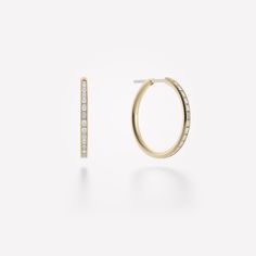 The Miri Hoop Earrings are 20mm 18k gold hoops with channel-set baguette diamonds (approx. 1.0 tcw). Available in 18k yellow, white or rose gold. Diamonds- channel-set white baguette cut diamonds (approx. 1.0 tcw) Hoops- 18k gold, 20mm in diameter Posts- 18k white gold Created in 2018 Yellow Gold Diamond Hoop Earrings With Baguette Diamonds, Yellow Gold Hoop Diamond Earrings With Baguette Diamonds, Yellow Gold Baguette Diamond Hoop Earrings, Small Hoop Earrings In Yellow Gold With Baguette Diamonds, Small Hoop Yellow Gold Earrings With Baguette Diamonds, Luxury Yellow Gold Hoop Earrings With Baguette Diamonds, Luxury Gold Hoop Earrings Baguette Cut, Luxury Gold Hoop Earrings With Baguette Diamonds, Small Hoop Earrings With Baguette Diamonds In Yellow Gold