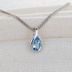 Elegant pear topaz in a rubover setting. Natural African blue topaz 6mm long by 4mm giving a total carat weight of 0.5ct. Topaz are associated with love, self esteem and good fortune. They are the birthstone for December. This elegant pendant is suitable to wear for daytime or evening wear. It is supplied on a 18 inch sterling silver chain. Both the pendant and chain are finished with a commercial grade rhodium plate to give a high quality shine finish. Supplied in an Ojewellery presentation box Pear-shaped Blue Topaz Jewelry As A Gift, Pear Shaped Blue Topaz Jewelry Gift, Pear Shaped Blue Topaz Jewelry For Gifts, Pear-shaped Blue Topaz Jewelry For Gifts, Silver Pear-shaped Blue Topaz Jewelry, Topaz Necklace, Blue Pendant, Elegant Pendant, December Birthstone