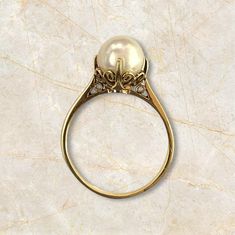 Elevate your style with this elegant 14K Yellow Gold Pearl Ring. Featuring a lustrous pearl measuring 8mm, this ring weighs 2.67 grams and is sized at 6.5. Perfectly combining sophistication with a touch of luxury, this ring is an exquisite addition to any jewelry collection. Material: 14K Yellow Gold Selling Price: $1099  A free online diamond appraisal is included upon request. Gold Pearl Ring, Mikimoto Pearls, Sell Gold, Gold Pearl, Pearl Ring, Free Online, Jewelry Collection, Jewelry Watches, Jewelry Rings