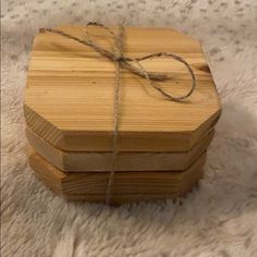 two wooden boxes tied with twine on white carpet