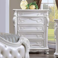 a white dresser and chair in a room