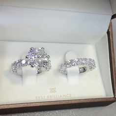 two engagement rings in a box with diamonds