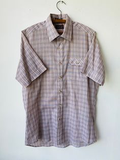 Vtg Levi's action short sleeved plaid button up shirt  Levi's Action Shirt Dimensions: Top center collar to end of sleeve-19" Pit to Pit: 20.5" Top of Collar to bottom waist seam- 32.5 Levi's Button-up Tops, Relaxed Fit Plaid Short Sleeve Button-up Shirt, Plaid Relaxed Fit Short Sleeve Button-up Shirt, Plaid Short Sleeve Camp Shirt With Relaxed Fit, Plaid Cotton Short Sleeve Shirt With Button Closure, Relaxed Fit Plaid Collared Short Sleeve Shirt, Relaxed Fit Collared Short Sleeve Plaid Shirt, Classic Plaid Cotton Short Sleeve Shirt, Collared Plaid Short Sleeve Shirt With Relaxed Fit