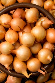 a basket filled with onions sitting on top of a table