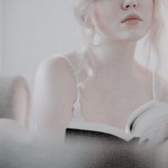 a woman with blonde hair is reading a book