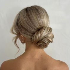 a woman with blonde hair in a low bun