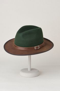 Bask in your own outback adventure with the Pinnacle, exquisitely created in bold two-tone and tone-on-tone styles. Whether you're exploring a dusty trail or strolling along a shimmering stream, this handmade, 100% wool hat will shade you with its wide, cowhide leather brim. Accented with a leather band and buckle, the Pinnacle is appointed with an interior drawstring sweatband to keep you cool and ensure a comfortable fit. Fall Six-panel Hat For Outdoor, Fall Six-panel Outdoor Hat, Fall Outdoor Six-panel Hat, Western Green Hat For Outdoor, Green Western Hat For Outdoor, Green Outdoor Hat For Fall, Green Fedora For Outdoor, Country Style Leather Felt Hat For Outdoor, Leather Country Style Felt Hat For Outdoor