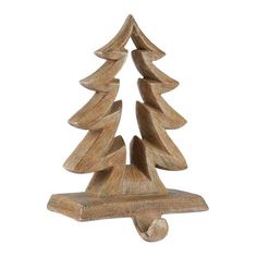 a small wooden christmas tree on a white background