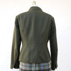 Olive green wool fitted blazer jacket with long sleeves and metal buttons down the front. It is lined and has two front pockets. Size 4 Measurements with room for comfort: Bust up to: 34 1/2 inches Waist up to: 28 inches Exact measurements taken flat to compare to a garment which fits well: Length: 21 1/2 inches Sleeve length: 22 inches Shoulders across the back: 15 1/2 inches Bust: 18 inches Waist: 15 1/2 inches Designer/ Brand/ Label Talbots Petite Condition is excellent The skirt is listed he Fitted Wool Tweed Jacket With Long Sleeves, Green Fitted Blazer For Fall, Fitted Green Blazer For Fall, Fitted Tweed Jacket For Fall Semi-formal Occasions, Fitted Tweed Jacket For Fall Semi-formal Events, Fitted Tweed Jacket For Semi-formal Fall Events, Fitted Tweed Jacket For Semi-formal Fall Occasions, Classic Green Outerwear With Double Button Closure, Fitted Button-up Tweed Jacket With Pockets