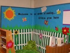 a child's room decorated in blue and green with flowers on the fence, sunflowers painted on the wall