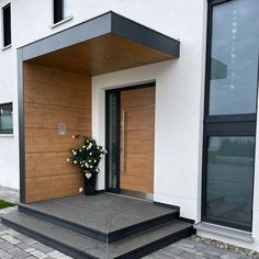 an entrance to a building with flowers on the steps