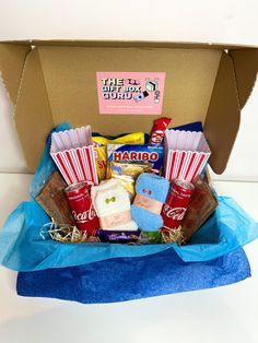 an open box filled with snacks and candy