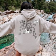 "Everyone needs a cozy go-to hoodie to curl up in, so go for one that's soft, smooth, and stylish. It's the perfect choice for cooler evenings! Chinese characters \"万事开头难 (Wànshì kāitóu nán)\" meaning - \"Every Beginning is difficult.\" Welcome to Ryn Cyanus Designs!! I'm thrilled to see you here! My main purpose is to meet you with a high-quality product. I use the best product to make you happy. Let me know if you would like to see different items or designs through my store. Enjoy your shopping! * 50% pre-shrunk cotton, 50% polyester * Fabric weight: 8.0 oz/yd² (271.25 g/m²) * Air-jet spun yarn with a soft feel and reduced pilling * Double-lined hood with matching drawcord * Quarter-turned body to avoid crease down the middle * 1 × 1 athletic rib-knit cuffs and waistband with spandex * Hooded Sweater With Graphic Print And Relaxed Fit, Hooded Graphic Print Sweater With Relaxed Fit, Cozy Long Sleeve Hoodie With Graphic Print, Cozy Hooded Sweatshirt With Graphic Print, Fleece Hoodie With Graphic Print For Loungewear, Graphic Print Fleece Hoodie For Loungewear, Cozy Hoodie With Graphic Print, Relaxed Fit, Cozy Relaxed Fit Hoodie With Graphic Print, Graphic Jackets