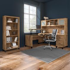 an office with blue walls and wooden furniture in the corner, along with a rug on the floor