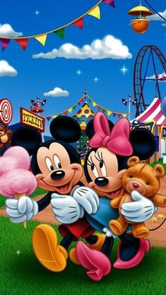 mickey and minnie hugging in front of an amusement park