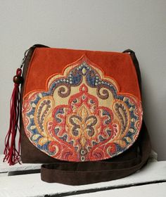 Orange and brown messenger bag Boho bag Vegan crossbody bag Oriental bag Medium sized bag Oriental purse Evening bag Christmas gift idea -Medium sized messenger bag with adjustable strap -Simple style -Flap with decorative badge -Inside lining with two pocket -Bag closed by magnet -Bag made from eco suede -Bag decorated with hand-made tassel Width 10,24- 11,81 in / 26- 30 cm height 9,84 in / 25 cm Care: wash in hands and lay flat to dry. Real colors may differ slightly from their appearance on y Medium Size Crossbody Purse, Brown Crossbody Shoulder Bag With Mobile Phone Pocket, Brown Crossbody Shoulder Bag With Removable Pouch, Brown Satchel Shoulder Bag With Mobile Phone Pocket, Brown Satchel Backpack With Mobile Phone Bag, Brown Crossbody Hobo Bag With Removable Pouch, Brown Satchel Flap Bag With Removable Pouch, Brown Travel Flap Bag With Phone Pocket, Brown Travel Flap Bag With Mobile Phone Pocket