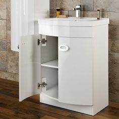 a white cabinet with a sink and mirror on it next to a wall mounted faucet