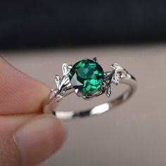 a person holding a green ring with leaves on it