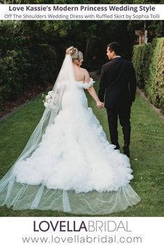 a bride and groom holding hands walking through the grass