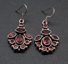 Beautiful Vintage Art Deco Stamep 925 Sterling Silver & Red Garnet Cluster Drop Earrings pre/owned condition measures 1 5/8" x 3/4" width. Ornate Red Sterling Silver Earrings, Vintage Red Sterling Silver Earrings, Red Vintage Sterling Silver Earrings, Red Dangle Earrings Stamped 925, Ornate Red Earrings For Formal Occasions, Traditional 925 Stamped Silver Earrings For Formal Occasions, Red Oval Garnet Earrings, Traditional Oval Red Earrings, Red Garnet Round Earrings