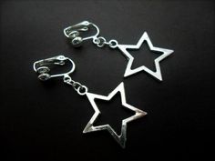 This a pair of pretty little tibetan silver dangly star clip on earrings. Measure approx. 3cm from top of hook to bottom of earring. These earrings are not for pierced ears. Freshly made by me and unworn. Thanks for looking!! Silver Dangle Clip-on Jewelry, Silver Clip-on Dangle Jewelry, Silver Star-shaped Hoop Earrings, Silver Clip-on Earrings For Jewelry Making, Silver Dangle Clip-on Earrings With Ear Wire, Metal Dangle Earrings With Star Charm, Silver Adjustable Star Earrings, Silver Star-shaped Earrings With Ear Wire, Silver Star Clip-on Earrings For Gift