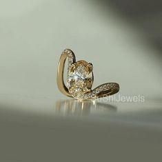 a yellow gold ring with an oval cut diamond