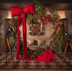 a living room decorated for christmas with red bows and presents