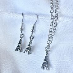 "One of our shop members made an earring and necklace out of these cute vintage style Eiffel Tower souvenir charms. Perfect for your favorite Parisienne (or Paris fan)!  These charms are petite so this is also a great gift for little ladies. Components: Eiffel Tower charms, wire hooks*, chain necklace  Dimensions: 18\" long necklace, charms are 5/8\" long Condition: New  These sets are available in bronze, silver and copper- all have an antiqued finish.  I'm happy to ship internationally- just m Cute Nickel-free Metal Charm Necklace, Cute Nickel-free Metal Charm Necklaces, Cute Metal Charm Necklace Nickel Free, Vintage Hypoallergenic Jewelry For Gift, Hypoallergenic Vintage Jewelry For Gift, Cute Nickel-free Pendant Jewelry, Silver Vintage Charm Earrings For Gift, Vintage Sterling Silver Adjustable Charm Necklace, Vintage Adjustable Sterling Silver Charm Necklace