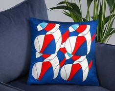 a blue couch with a red, white and blue pillow sitting on top of it