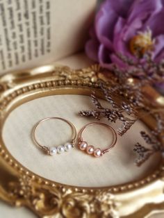 Three Pink Pearl Ring ✨ Three Stone Ring with Genuine Pink Pearls and 14K Gold Filled, Rose Gold Filled & Sterling Silver. June Birthstone Ring ✨💖 Triple pink pearl ring. Tiny & dainty ring with three small rose gold pearls. Make a very cute pinky ring.Sizing:• Gemstone Diameter: 4 mm• Ring Band: 0.8 mm• Handmade in your ring size with genuine freshwater pearls.• Gold-filled and sterling silver are known for their lasting quality. This will last for decades and is considered a lifetime piece of Pink Pearl Ring, June Birthstone Ring, Rose Gold Pearl, Pink Pearls, Three Stone Ring, Small Rose, June Birthstone, Pinky Ring, Three Stone Rings