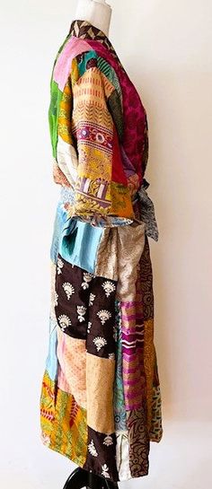 This stand-out kimono is full kaleidoscope of bright colors like a blooming spring garden. Constructed with high quality, ultra luxe sari silk, handmade. Designed as a traditional long kimono with an extra wide front band and self tie belt. Special detailing is noticable throughout the garment, double width hem panel, etc. Feels wonderful against your skin. Worn open, breezy flowing statement. The bright color pallet works well with most skin tones. True statement, one-of-a-kind designer piece. Multicolor Patchwork Kimono For Festivals, Multicolor Bohemian Kimono For Festivals, Handmade Multicolor Spring Kimono, Bohemian Silk Kimono For Festive Occasions, Multicolor Silk Kimono With Kimono Sleeves, Multicolor Handmade Kimono With Kimono Sleeves, Handmade Multicolor Kimono With Kimono Sleeves, Long Multicolor Silk Kimono, Multicolor Long Silk Kimono