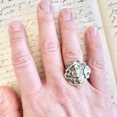 "Beautiful vintage Art Nouveau style sterling silver maiden statement ring. This special ring's age is a bit of a mystery but it is for sure a vintage ring. I believe it may be a conversation piece of jewelry, based on the design of the ring. The front of the ring features a maiden with wind swept hair and to the right of her hair, is a featured pansy flower. Her profile is right facing and the lovely features of her face have excellent detail. The inside of the ring band it is marked \"sterling Vintage Hand-cast Rings For Anniversary, Vintage Hand Cast Rings For Anniversary, Hand Cast Vintage Rings For Anniversary, Vintage Silver Hand Cast Ring, Vintage Silver Rings With Hand Cast Design, Artistic Silver Ring Collectible, Wind Swept Hair, Art Deco Locket, Pansy Flower