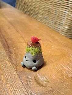 a small toy sitting on top of a wooden table