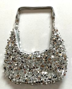 Sequin Handbags are hand-made, high quality, original designs, and beautiful. They are unique for evenings and special events and their designs are inspired by contemporary fashion and vintage looks. Sequin handbags are a perfect balance of aesthetics and functionality. Elegant Handheld Hobo Bag For Evening, Elegant Evening Handheld Hobo Bag, Elegant Evening Hobo Bag, Trendy Party Hobo Bag, Silver Tote Bag For Party, Trendy Hobo Bag With Removable Pouch For Party, Trendy Handheld Shoulder Bag For Party, Silver Rectangular Shoulder Bag For Summer, Trendy Silver Evening Bag With Removable Pouch