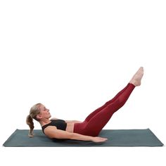 a woman is doing a yoga pose with her legs up on the ground and one leg in