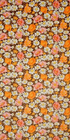 an orange and white flowered fabric with brown background