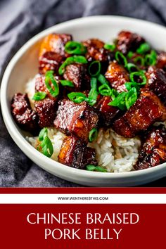 chinese braised pork belly served over rice in a white bowl with green garnish