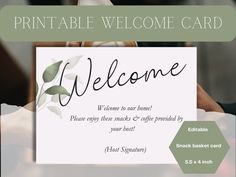 a welcome card is being held by two hands