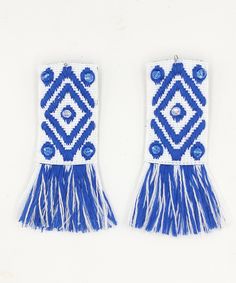 Handmade long blue and white earrings made from woven textile ribbon with fringes. They are embroidered with crystal seed beads. Everything is threaded by hand.The closure is from stainless steel. Bohemian style ,ideal for your vacation at Greek islands! These unique earrings are perfect for women who want stand out of the crowd . You can match them with a white simple shirt or a little dress.  Also they are ideal for summer outfits. DETAILS * Length 4 inches / 10 centimeters * Width 1.57 inches / 4 centimeters CARE TIPS *Do not wear your handmade jewelry while exercising. *Remove your jewelry when swimming, sunbathing and showering *Keep them away from chemicals like hairspray, body creams &   perfumes. *Carefully put on and put off. *Keep your handmade jewelry in a closed box. This produ Blue Beaded Fringe Tassel Earrings For Festivals, Blue Fringed Beaded Earrings For Festival, Summer Blue Beaded Earrings With Tassels, Blue Beaded Fringe Tassel Earrings For Summer, Traditional Blue Beaded Fringe Earrings, Traditional Fringe Earrings For Beach, Blue Beaded Fringe Earrings For Summer, Blue Fringe Beaded Earrings For Beach, Traditional Blue Tassel Earrings For Festival