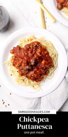 two white plates filled with spaghetti and sauce