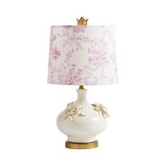 a white lamp with a pink shade on it